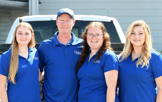 Family of TruBlue member standing in front of truck