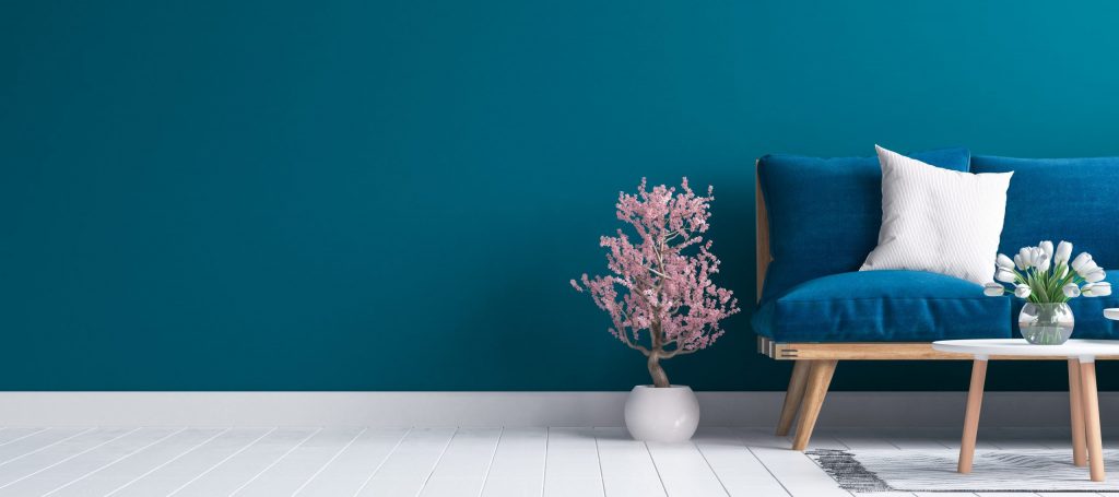 couch in front of blue wall