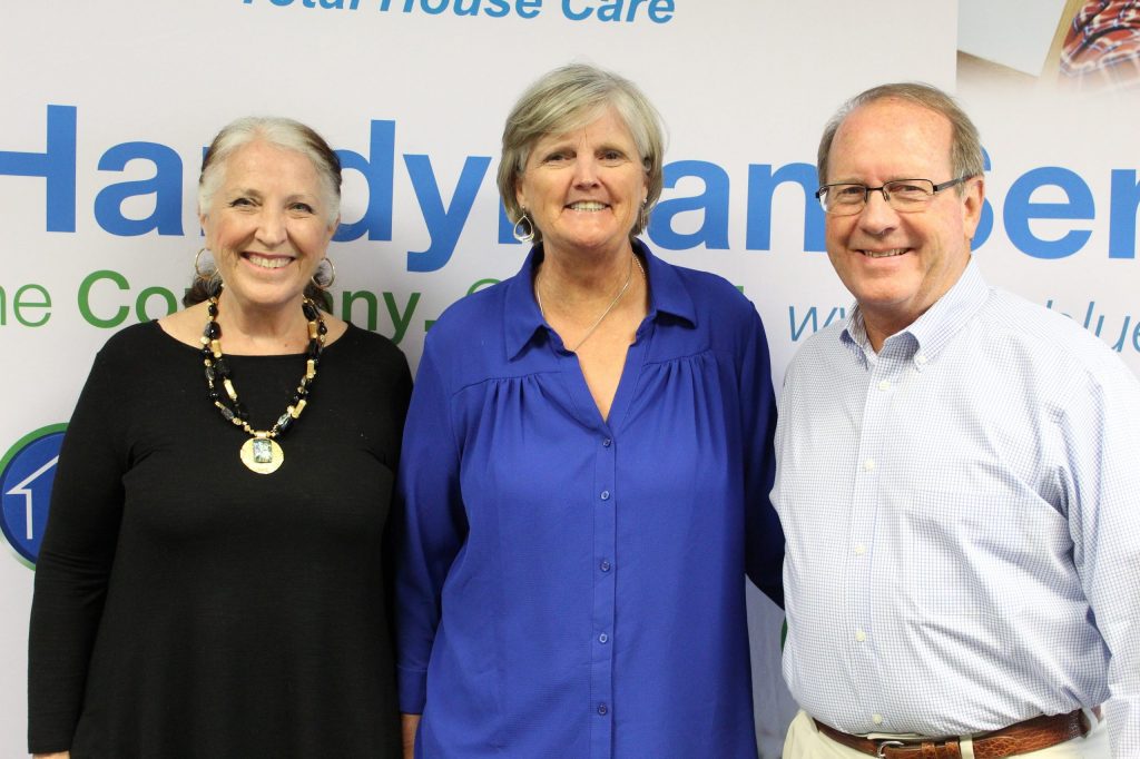 three franchisees posing in front of TruBlue background