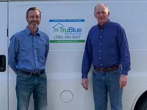 two franchisees standing in front of TruBlue truck